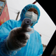 Photo of medical worker with temperature gun